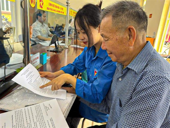 Lực lượng tình nguyện hỗ trợ người cao tuổi tiếp cận với các tiện ích số. Ảnh: TTXVN