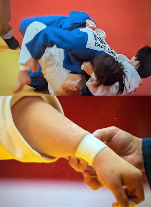 Cắn đối thủ giữa trận, võ sĩ Trung Quốc bị truất quyền thi đấu tại ASIAD 2026 - Ảnh 1. Cắn đối thủ giữa trận, võ sĩ Trung Quốc bị truất quyền thi đấu tại ASIAD 2026 - Ảnh 1.