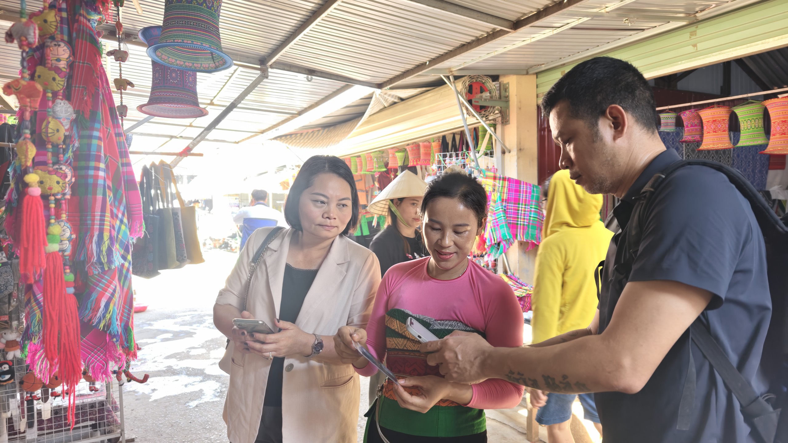 Phóng viên Thể thao và Văn hóa (bên phải) mua hàng và thanh toán bằng mã QR. Ảnh: Huy Thông