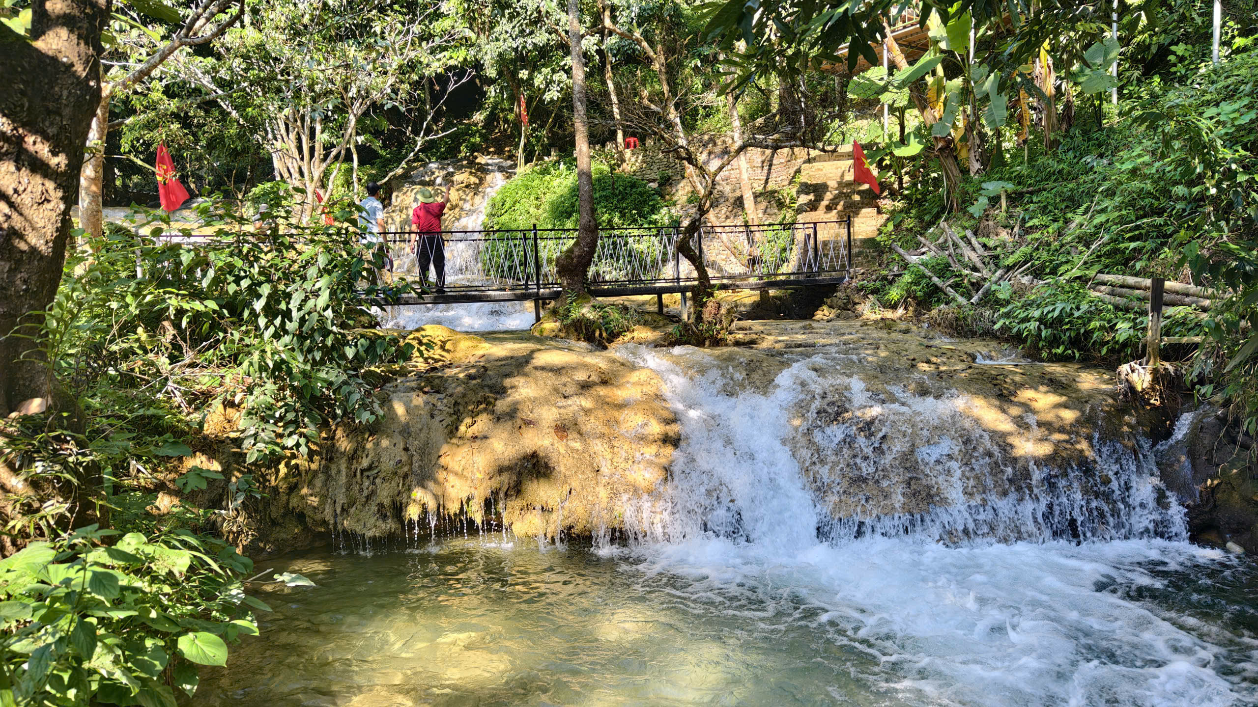 Giữa những tán cây rừng, thác Hiêu hiện ra với nhiều tầng nước nối tiếp. Ảnh: Huy Thông
