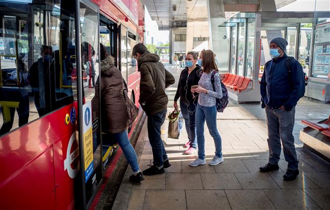 Trong ảnh: Hành khách đeo khẩu trang phòng dịch COVID-19 khi đi xe buýt tại London, Anh ngày 18/5/2020. Ảnh: AFP/TTXVN