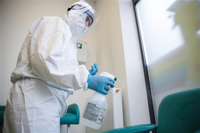 Nhân viên y tế phun thuốc khử trùng nhằm ngăn chặn sự lây lan của dịch COVID-19 tại Warsaw, Ba Lan. Ảnh: PAP/TTXVN phát