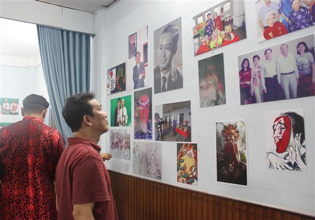 Khách mời xem hình ảnh, tư liệu về Nghệ sỹ nhân dân Đinh Bằng Phi tại triển lãm. Ảnh: Thu Hương - TTXVN