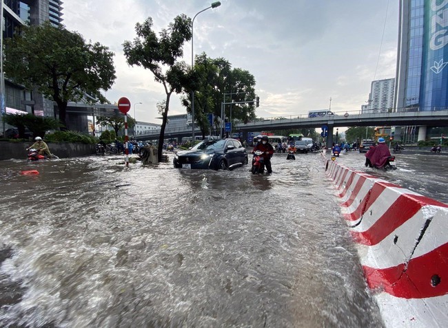 Nhiều điểm trên các tuyến phố Hà Nội ngập sâu sau mưa lớn, giao thông ùn tắc cục bộ - Ảnh 1.